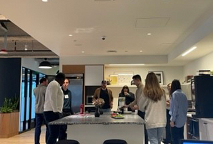 People gathered around a table talking and eating snacks