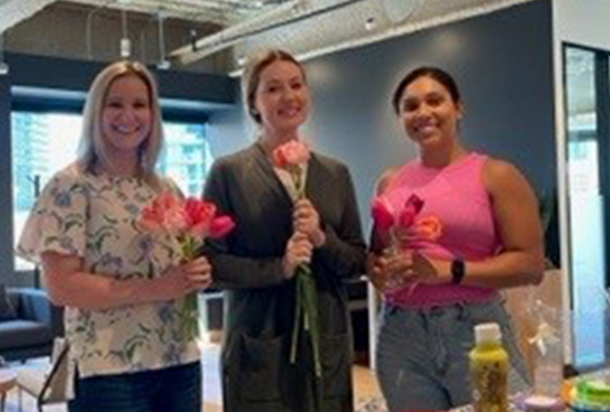 Three women holding flowers