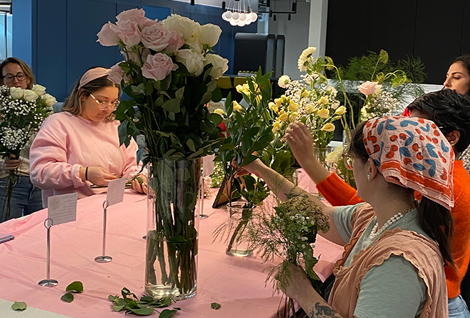 People looking at flowers on a table