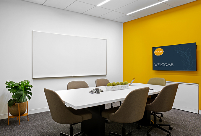 Small meeting room with a whiteboard and TV