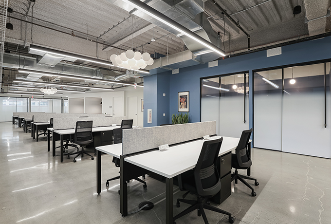 An open plan room with separated work stations