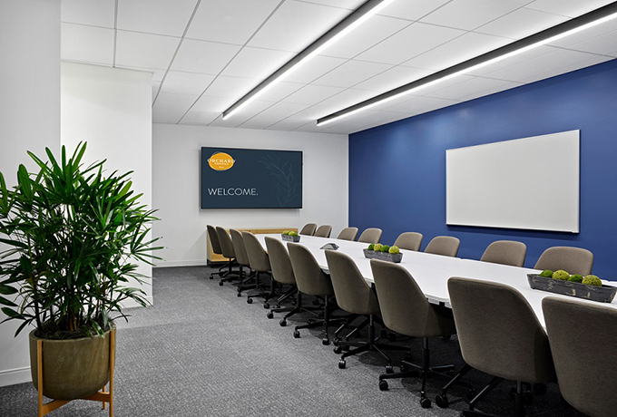 Large meeting room with a whiteboard and TV