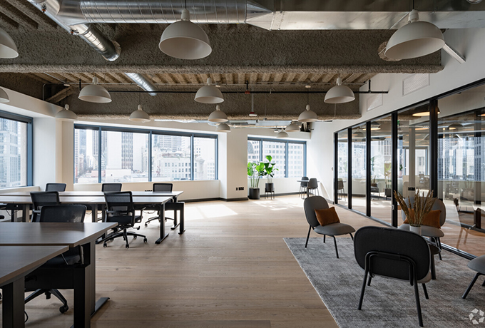 An open plan office space with a communal place at the front
