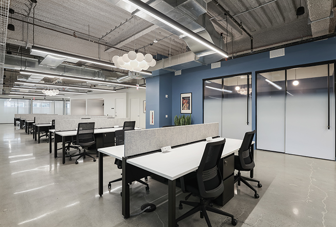 An open plan office space with multiple desks
